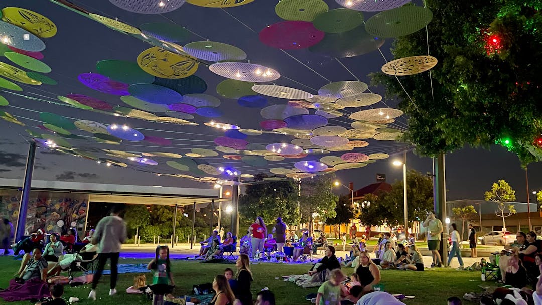 Beenleigh Town Square with coloured discs art intallation overhead. 