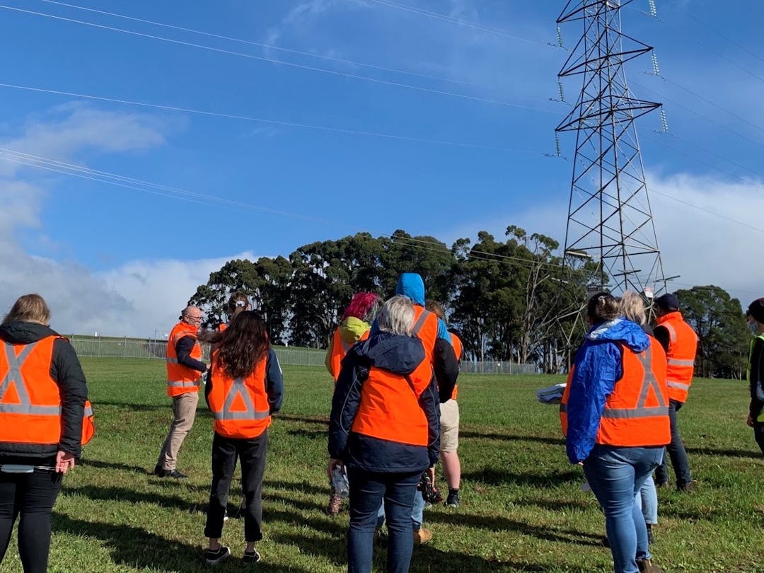 Photo of the youth panel members near a transmission tower