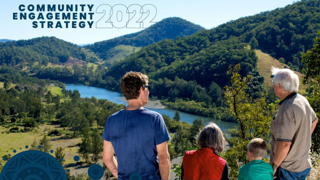 Cover of the 2022 Community Engagement Strategy featuring three adults and a child looking at a river and mountains