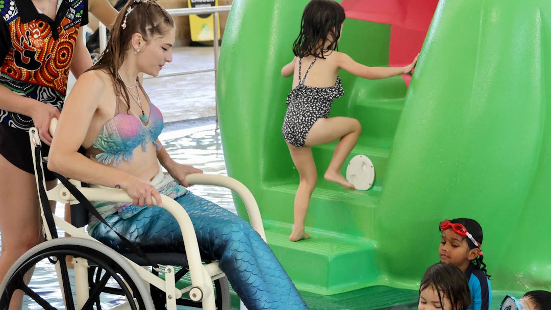 Mermaid in a wheelchair entertaining children at Beatty Park All Abilities Pool Party.