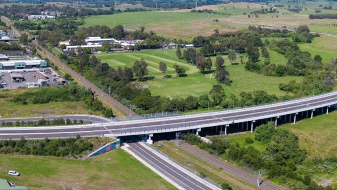 Aerial shot of Karrara Bridge over South Coast Rail Line and Mullet Creek in Dapto. 