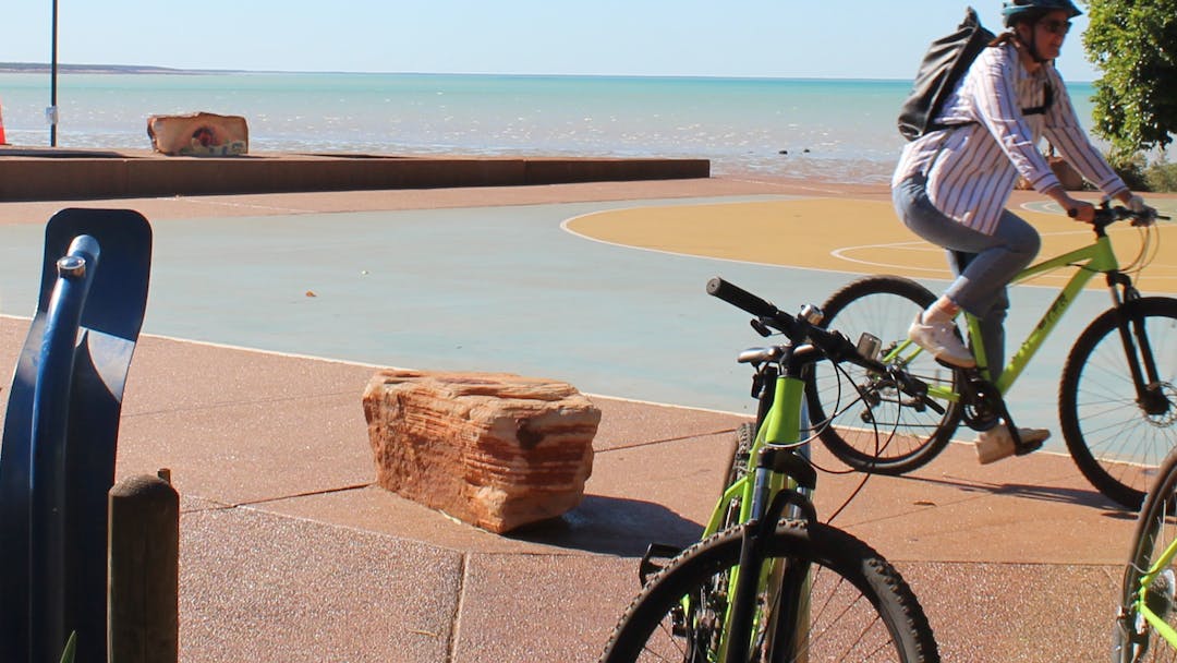 Person riding on path near the coast in the Kimberley