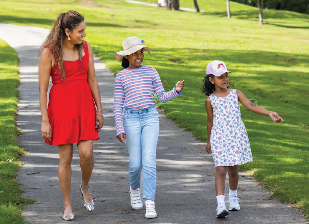 family of 3 walking along a pathway