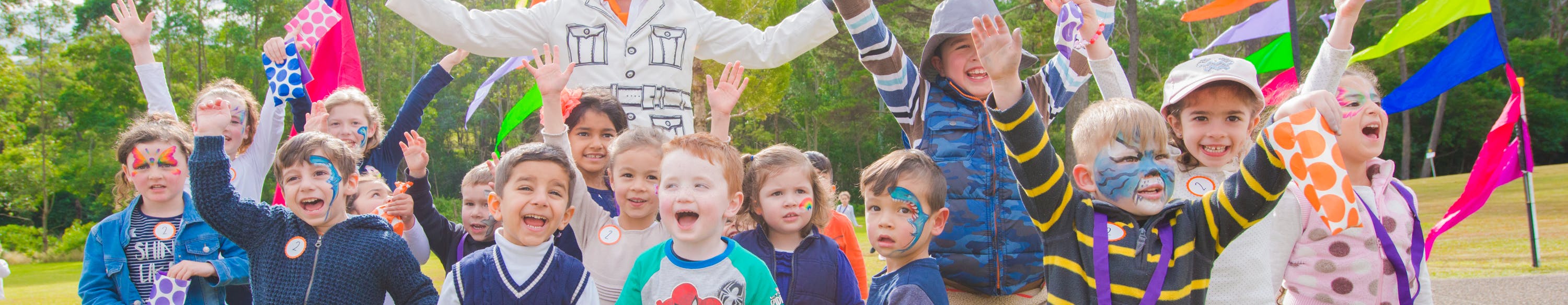 Children smiling and cheering at a Council event.