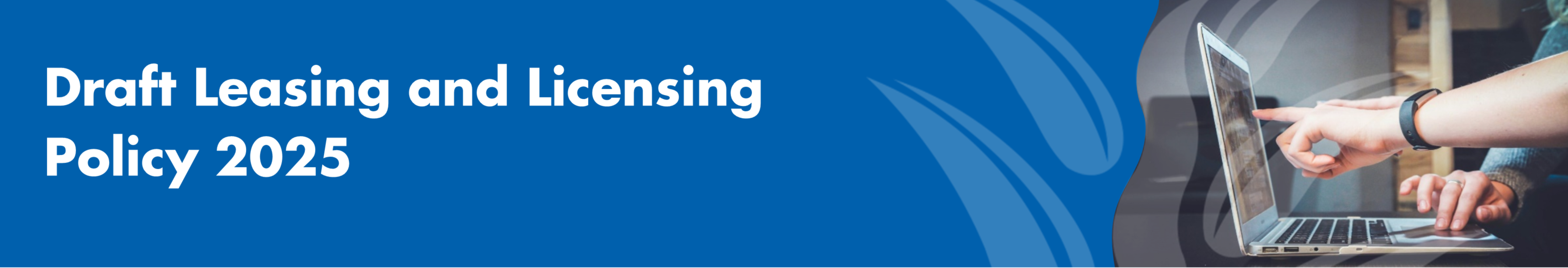 An image of a person pointing to a laptop, while another person uses the track pad