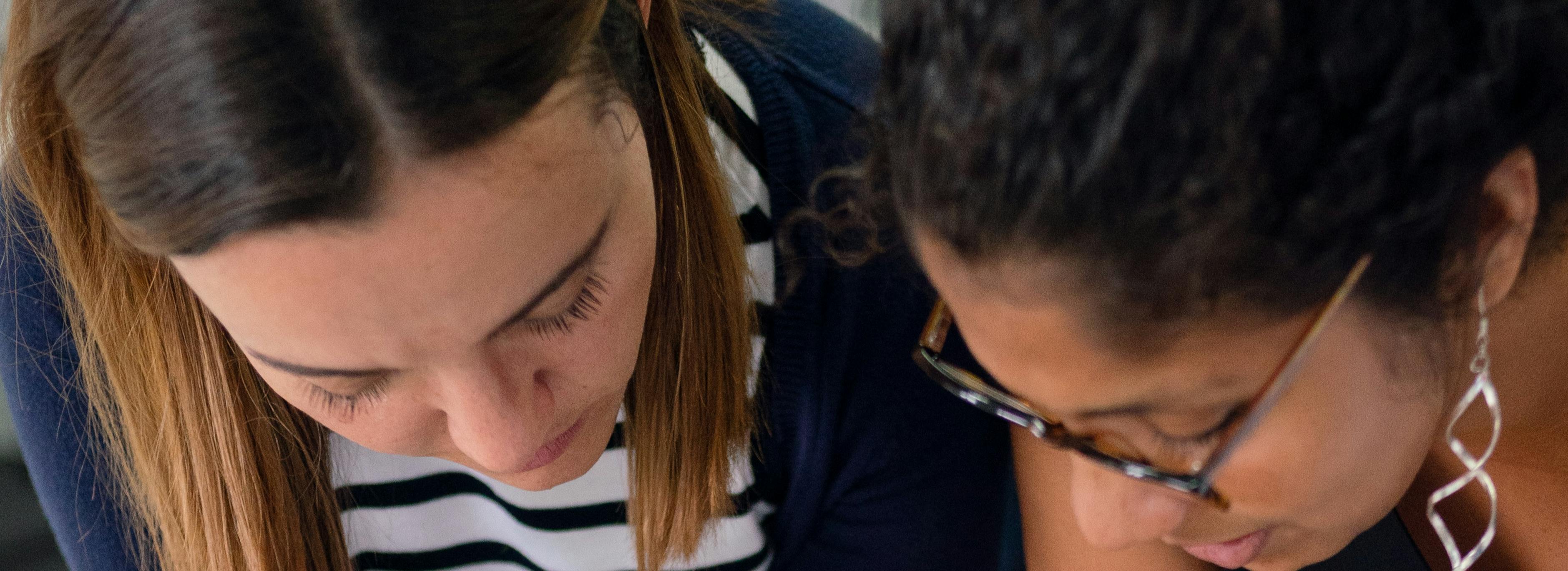 Two women planners discussing a plan 