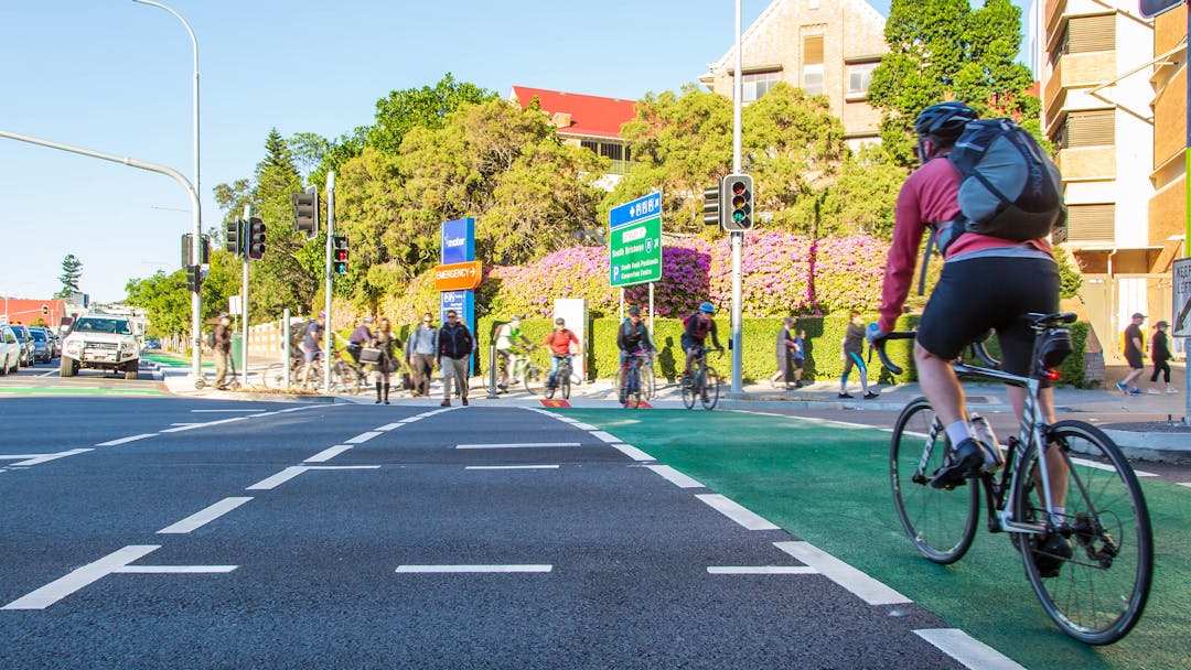 Image of cyclists riding across the road towards Annerley Road in Woolloongabba