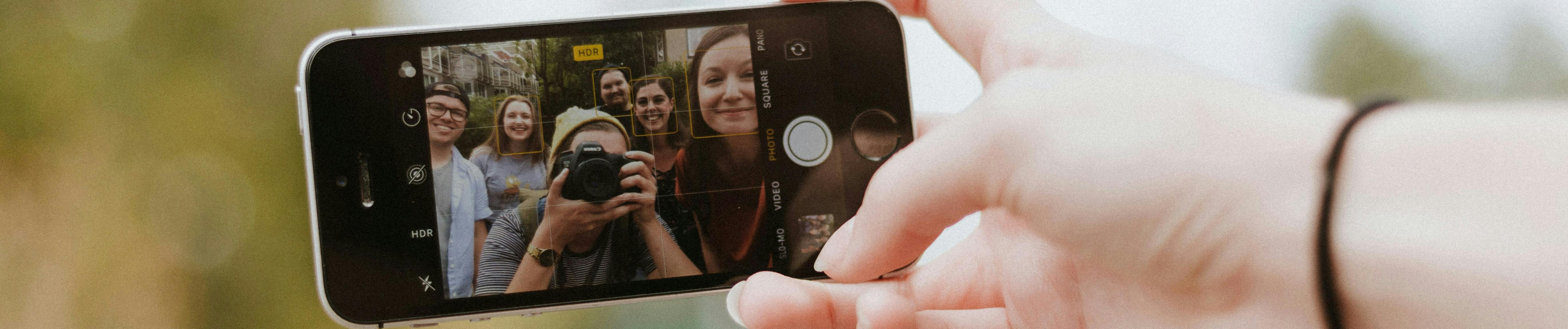 Selfie on iphone with the youth visible on the screen.