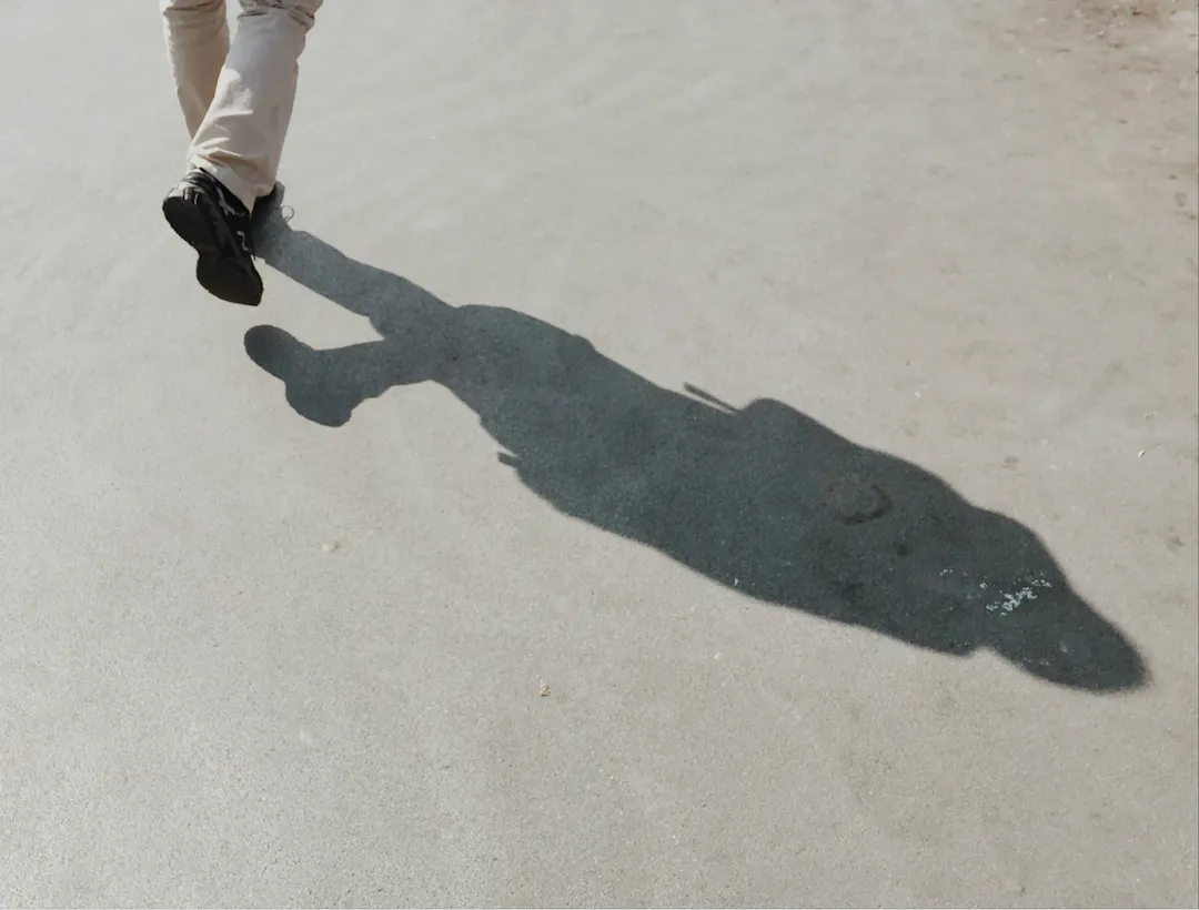 Person walking along concrete. 