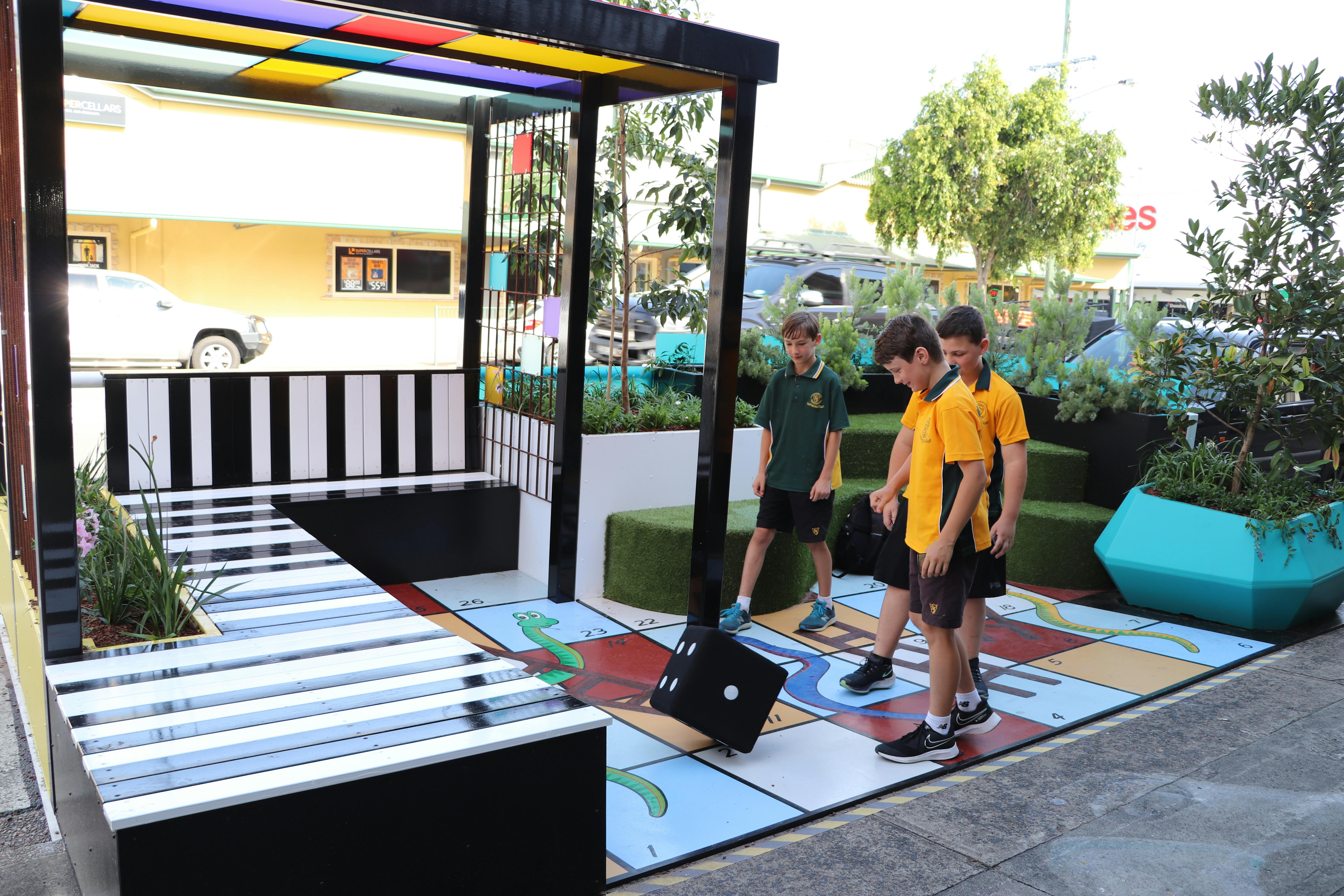 Playing a game of snakes and ladders at the Brisbane Street parklet