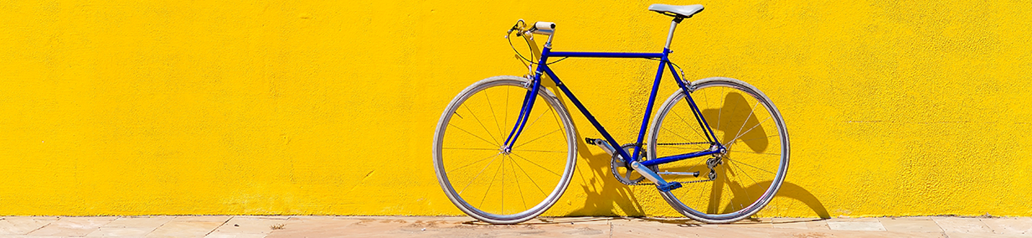A bike in front of a yellow wall