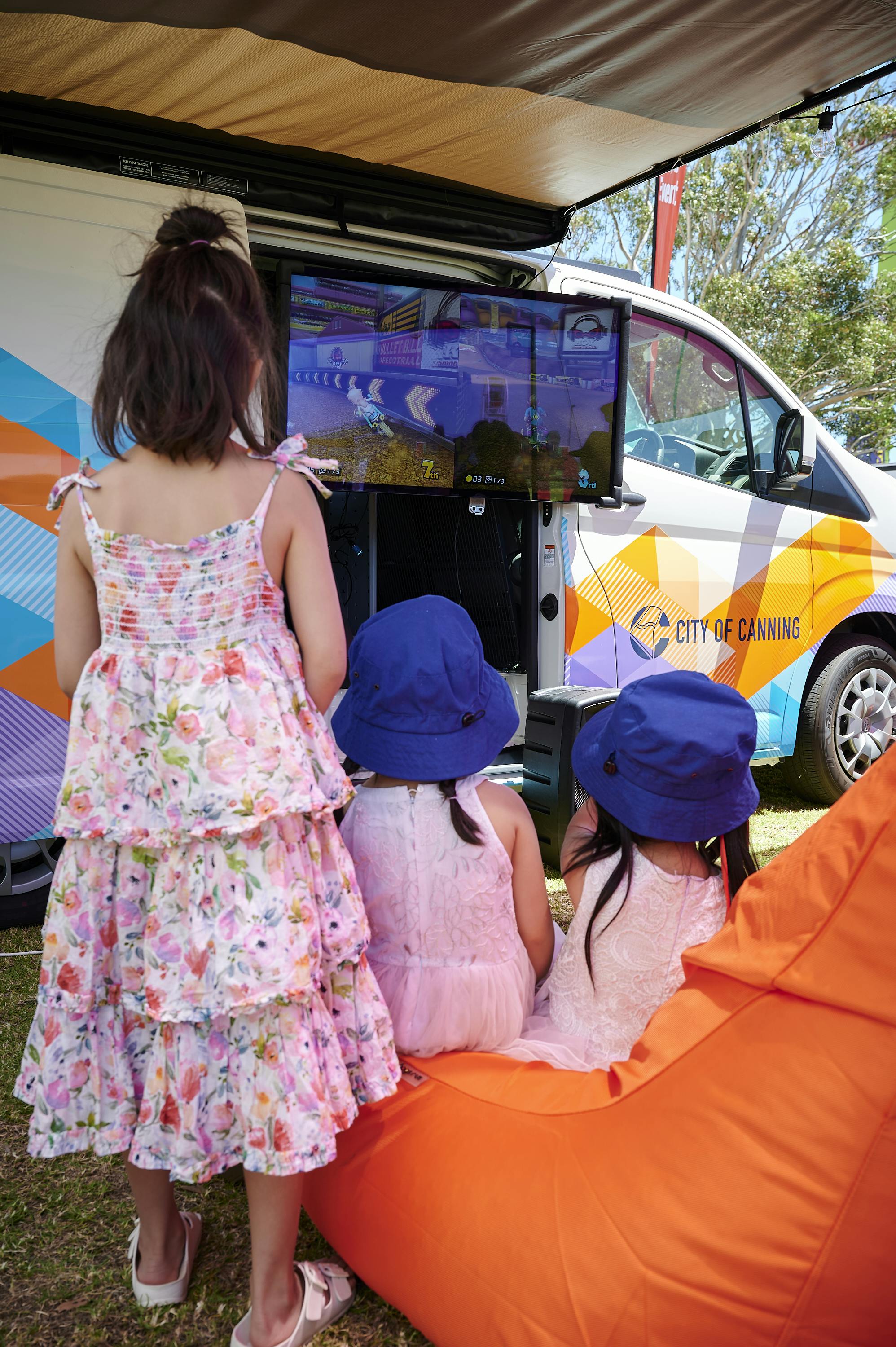 Children gaming with COG Van and Screen.