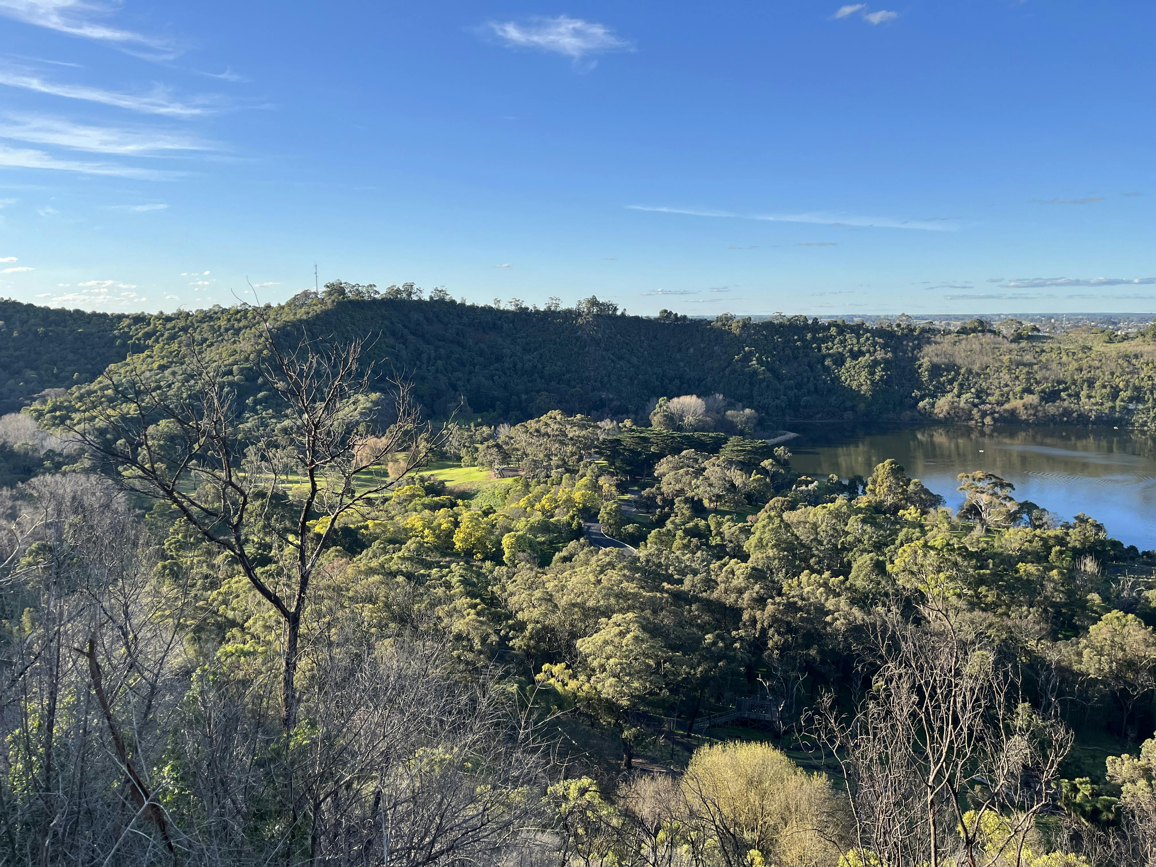 Green hilly view with lake on the right