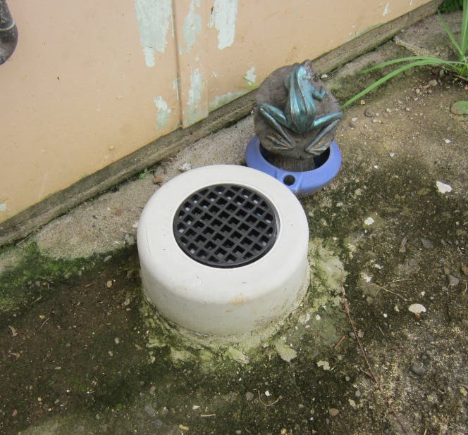 A correctly installed overflow relief gully which is higher than ground level to prevent unwanted stormwater inflow