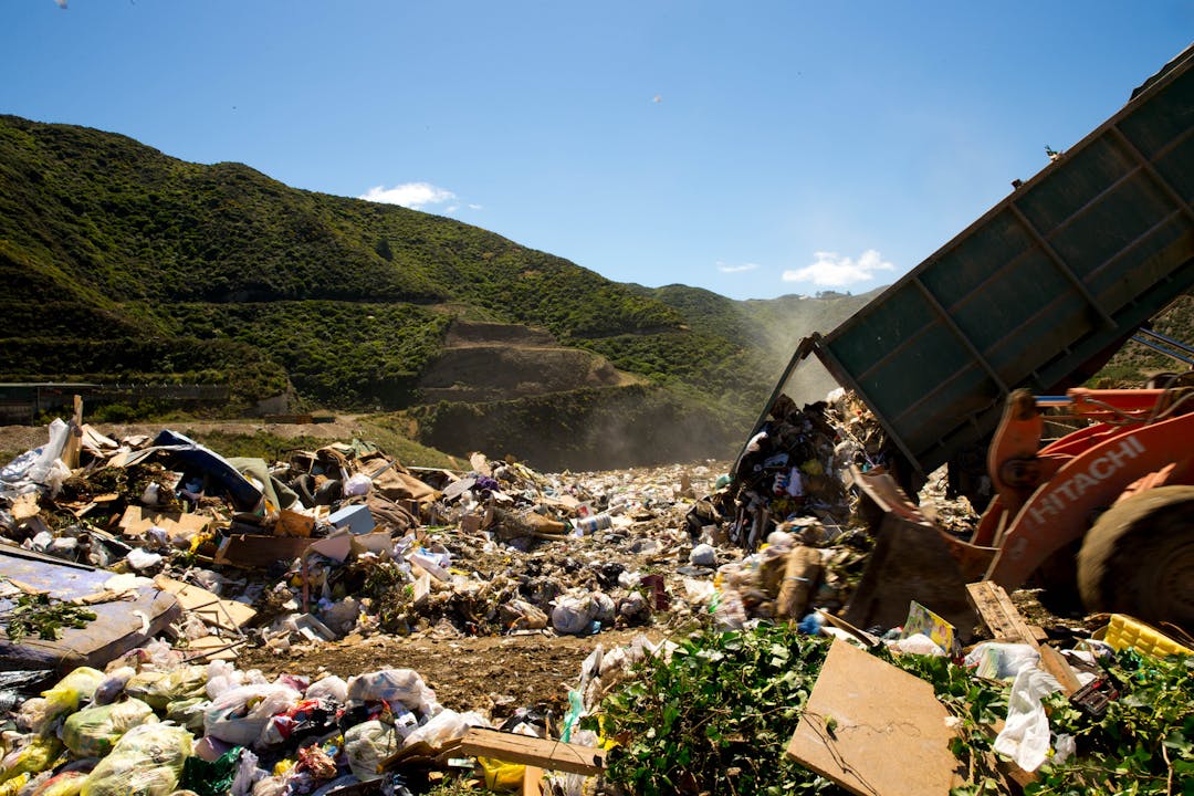 Photo of rubbish truck dumping waste at landfill