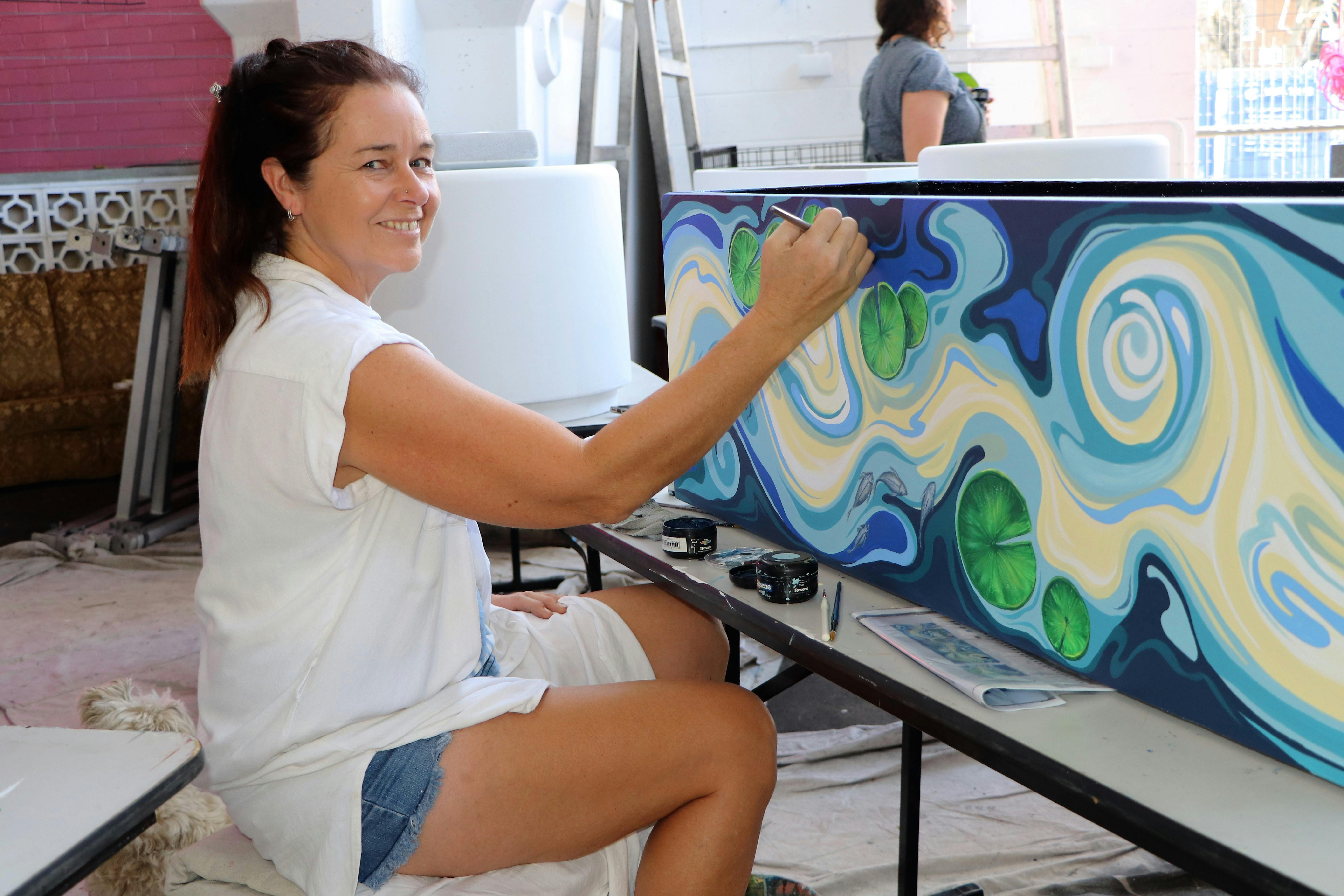 Mealie Batchelor paints her water themed planter box