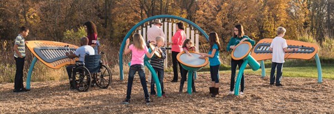 Large musical instrument like play equipment with many children
