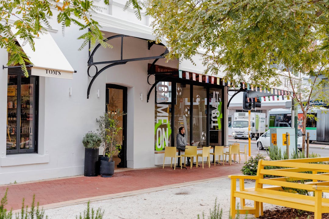 Public thoroughfare with cafe and outdoor seating areas.