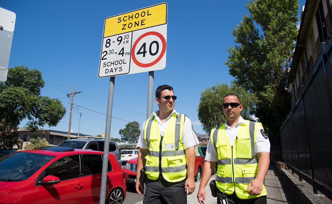 Council rangers walking on footpath in uniform