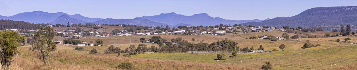 Open fields and mountain scene looking from Steggart Road towards the distant township of Hoya