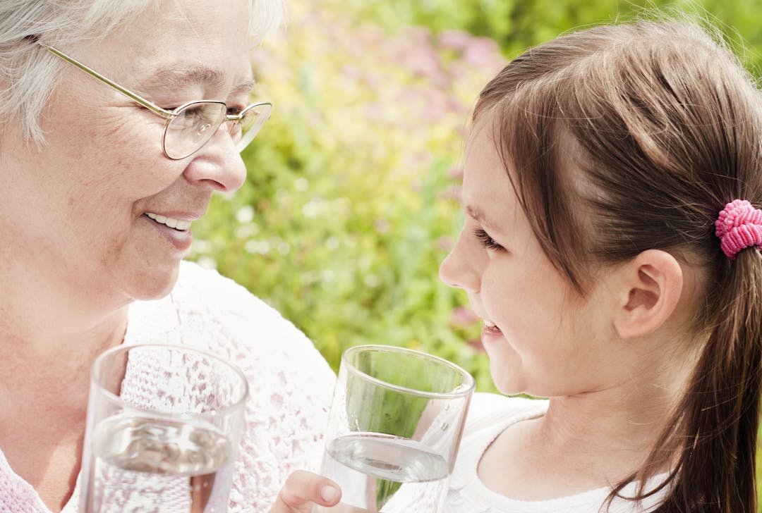 Image showing older female and girl with glasses of water