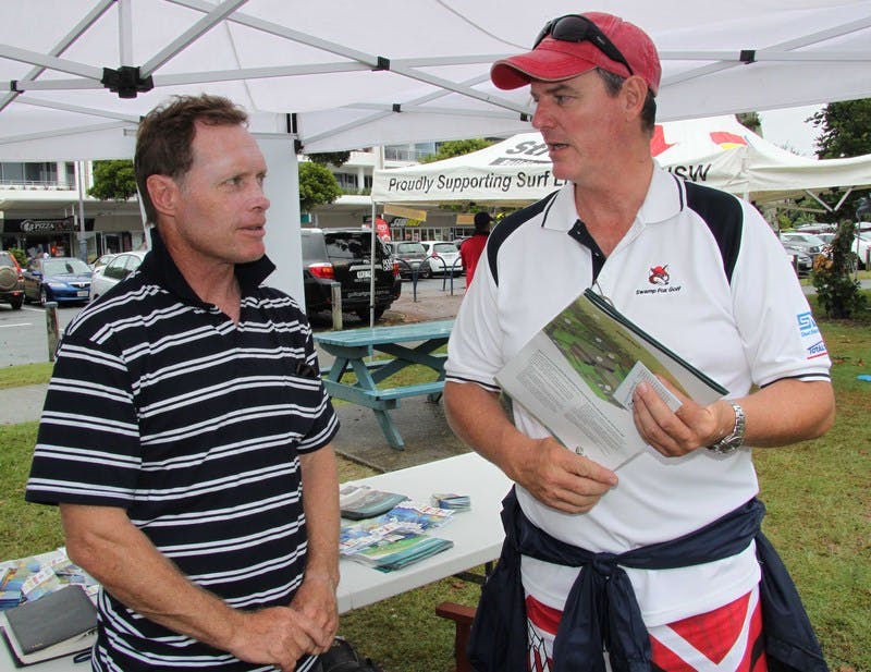 Kingscliff resident Kevin Schriek talks to Tweed Shire Council's Senior Design Engineer, Warren Boyd, during the community information stall at the NSW Surf Life Saving Championships.