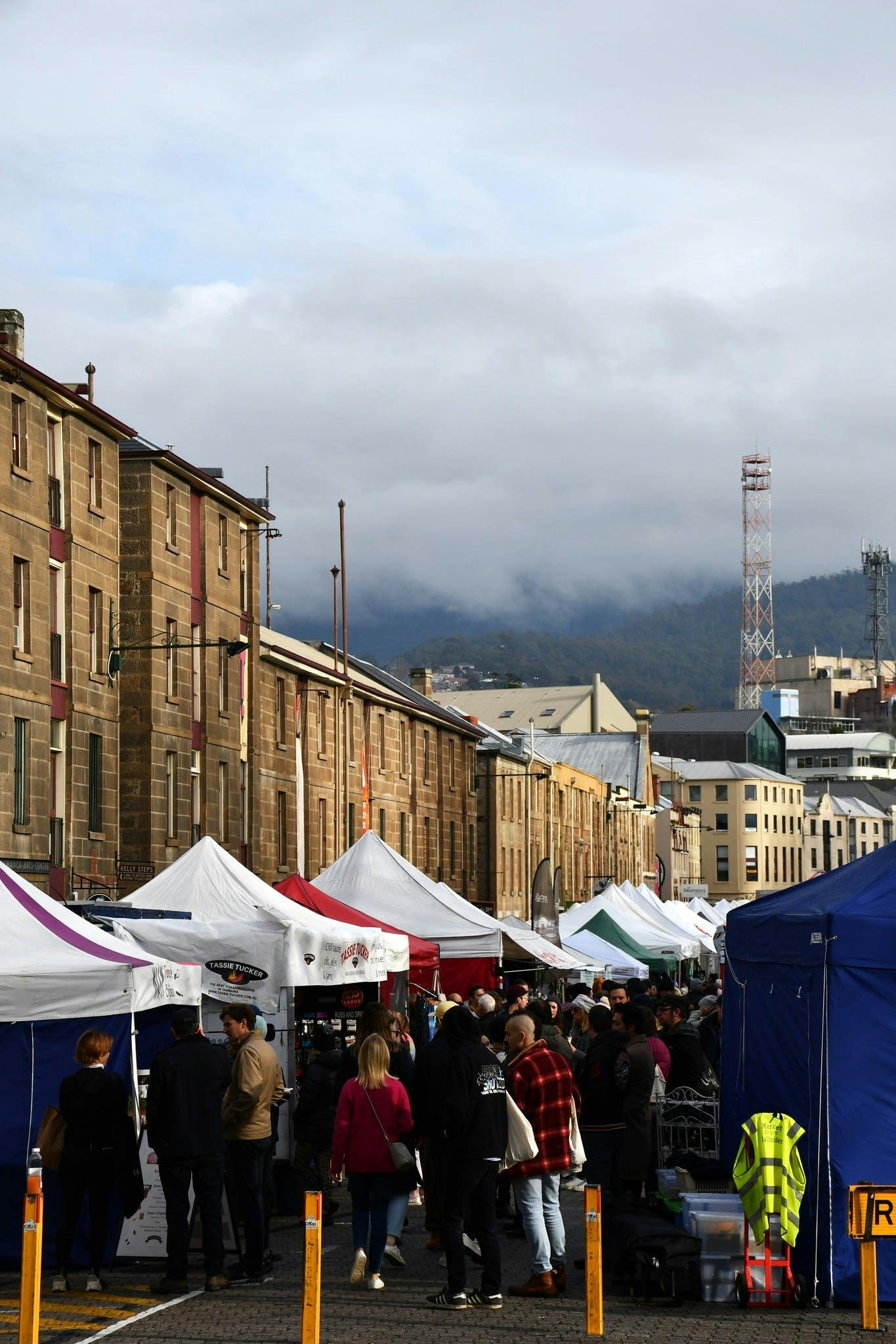 Image on Salamanca market with clouds over kunanyi/Mt Wellington in the background
