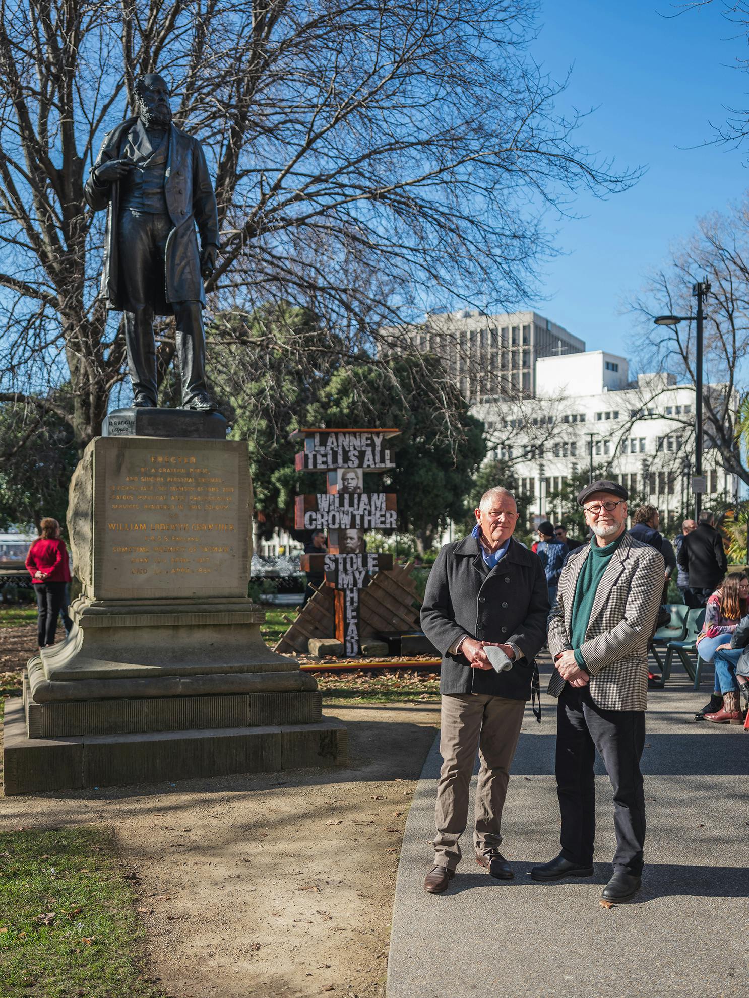Artists Roger Scholes and Greg Lehman in front of their artwork The Lanney Pillar and the statue of William Crowther