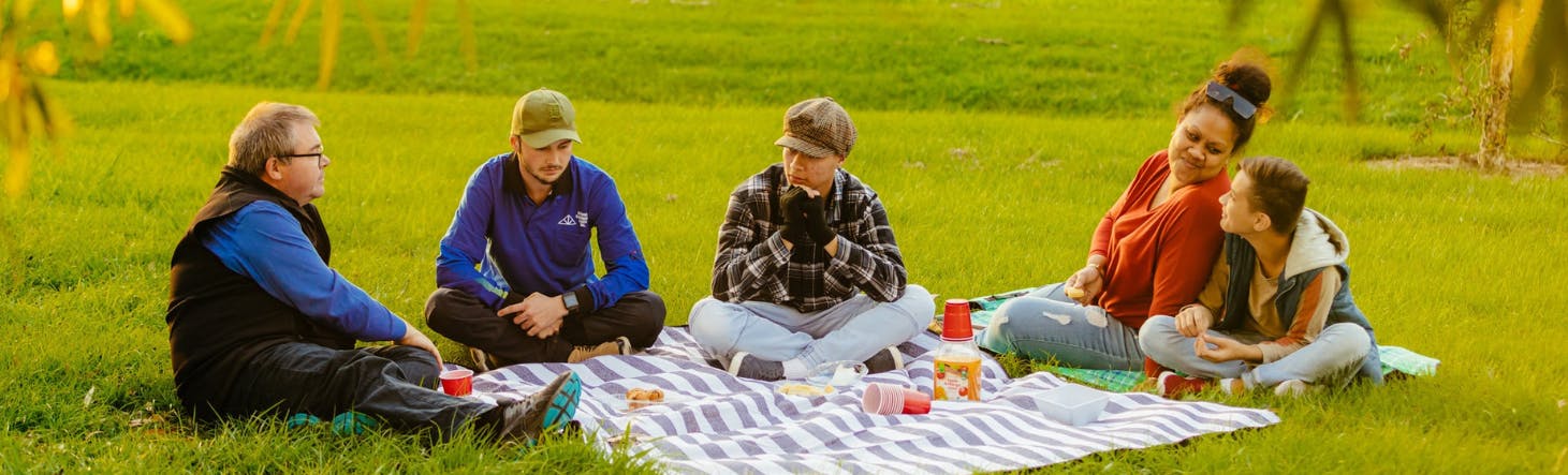 People chatting at a picnic at a park