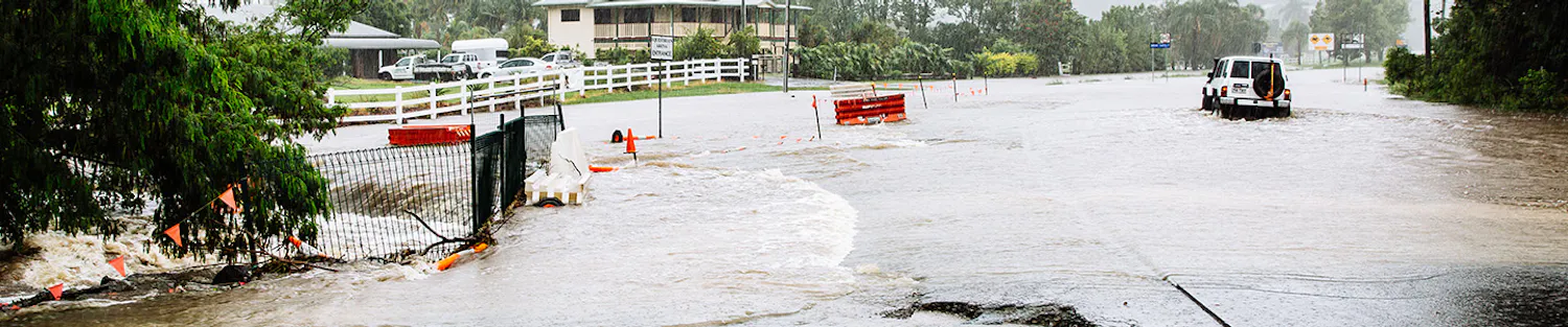 White 4 wheel drive car driving through flood waters