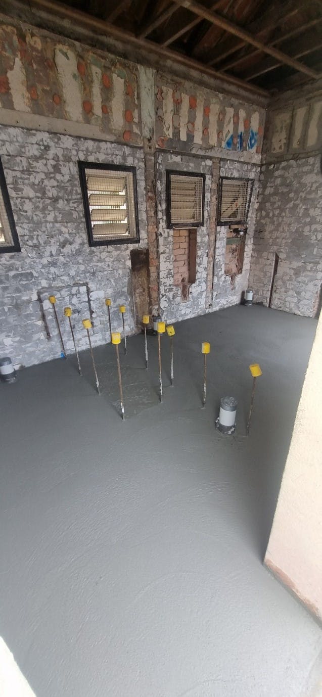 Floor slab poured with starter bars for new block walls - Barolin St Toilet Block.jpg