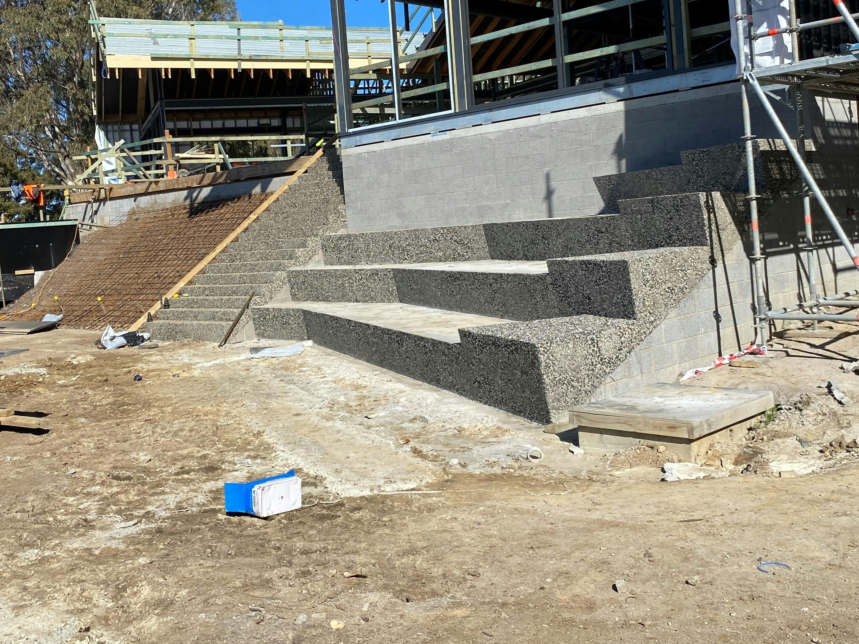 Bleacher seating underway. Handrails will be installed on the steps leading up to the building