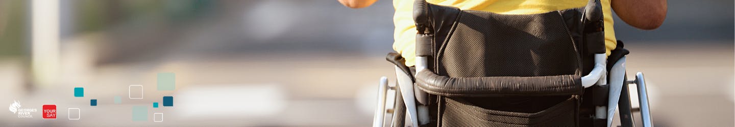 closeup of back of a man in a wheelchair with Council Your Say Logo