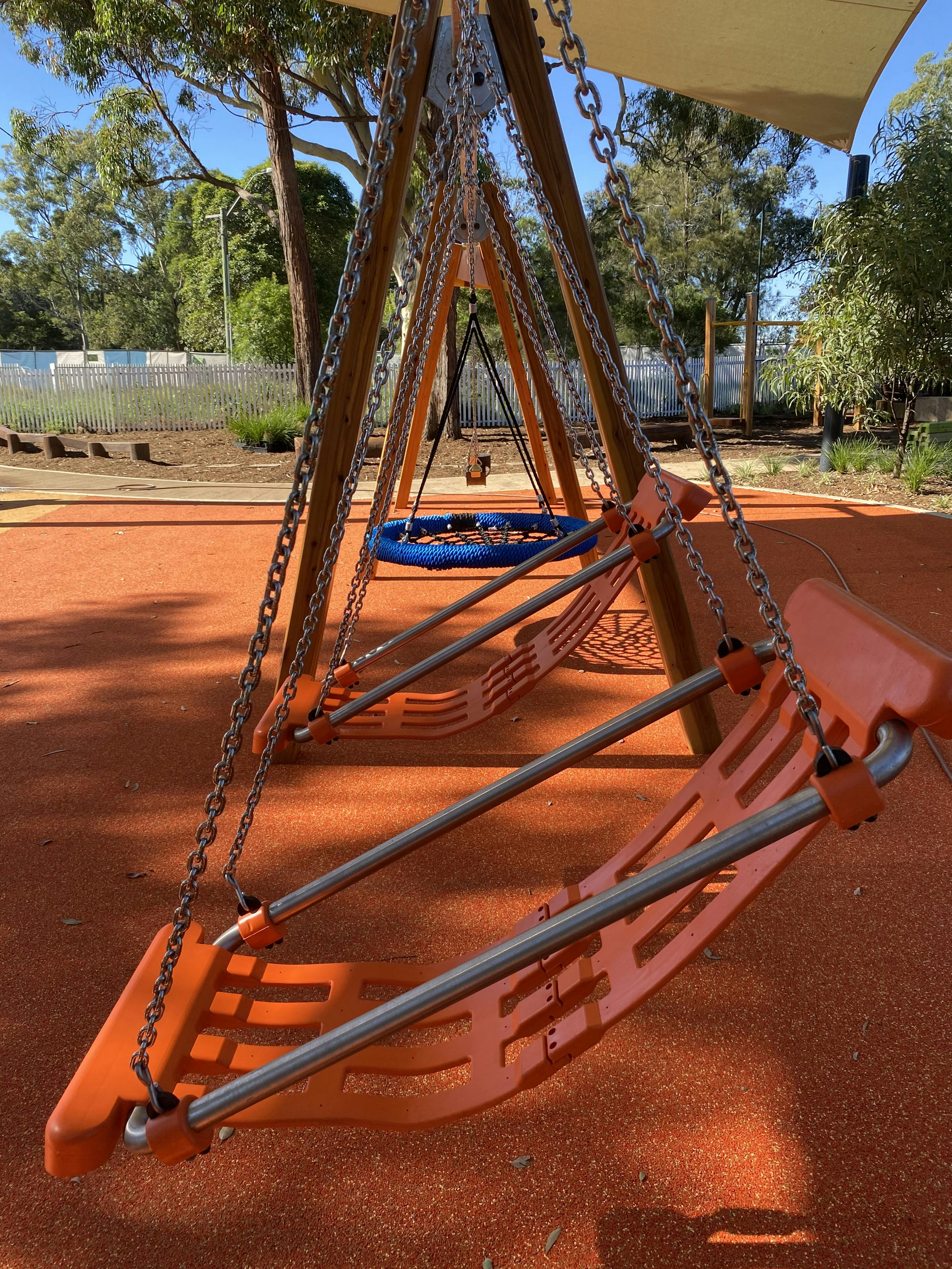 Inclusive swing set under shade sails