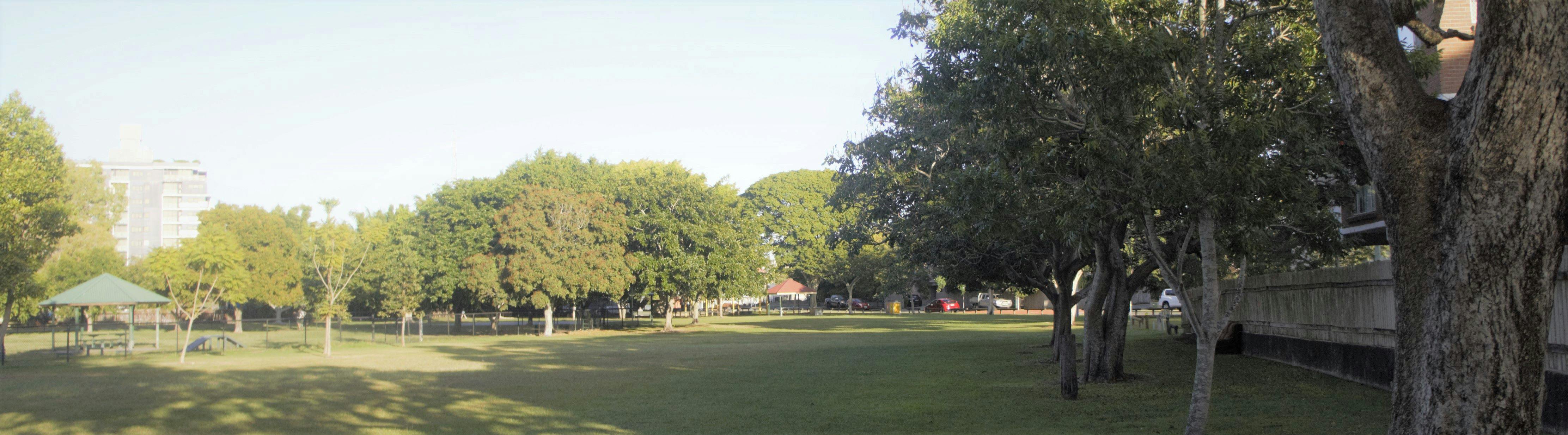 Woolloongabba Rotary Park looking toward the playground with dog park to the left and unit block fence to the right.