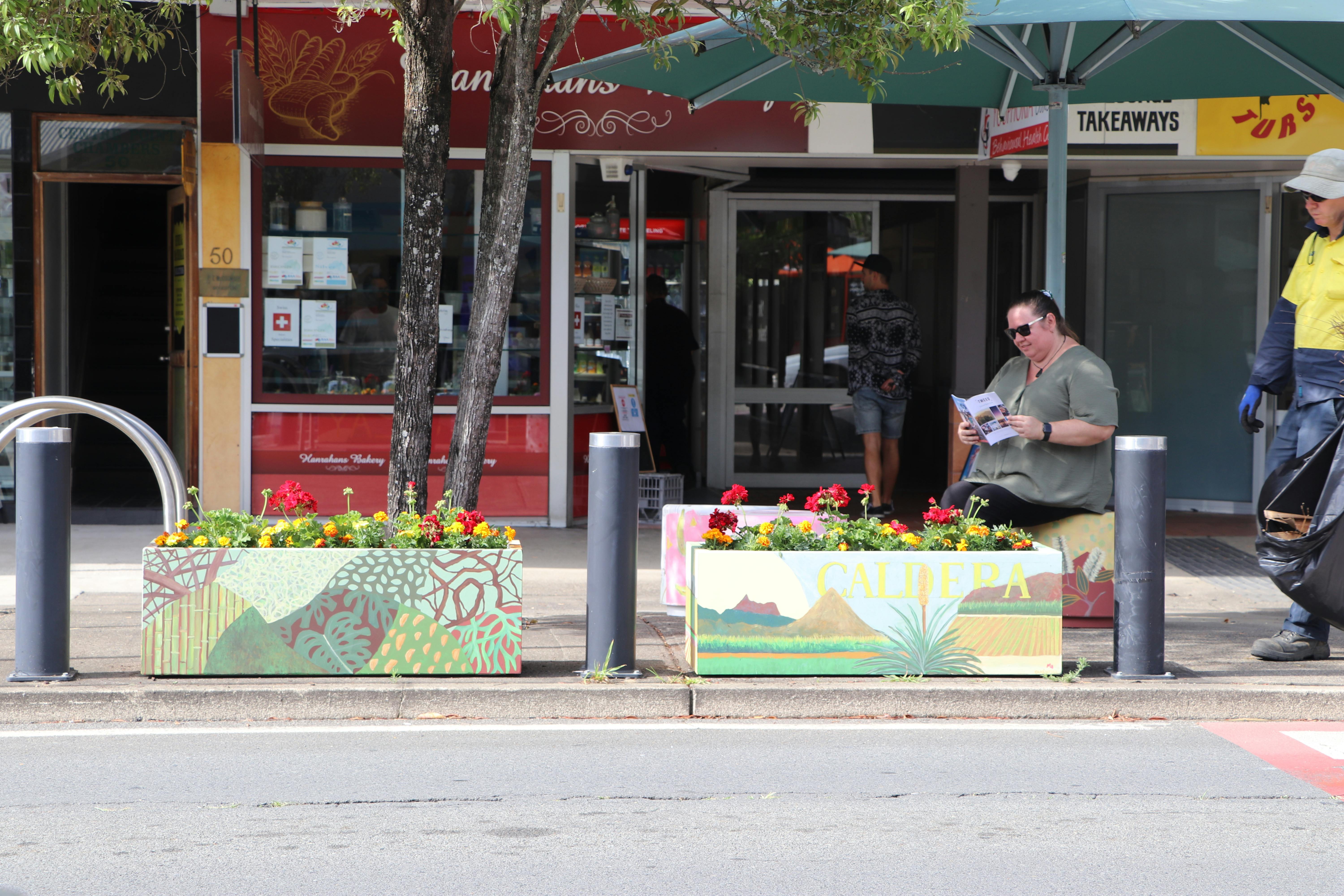 Art seats and planter boxes on display Behind the scenes parklets