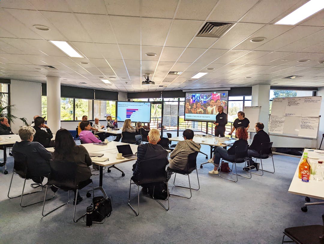 Group of people in a meeting looking at a presentation