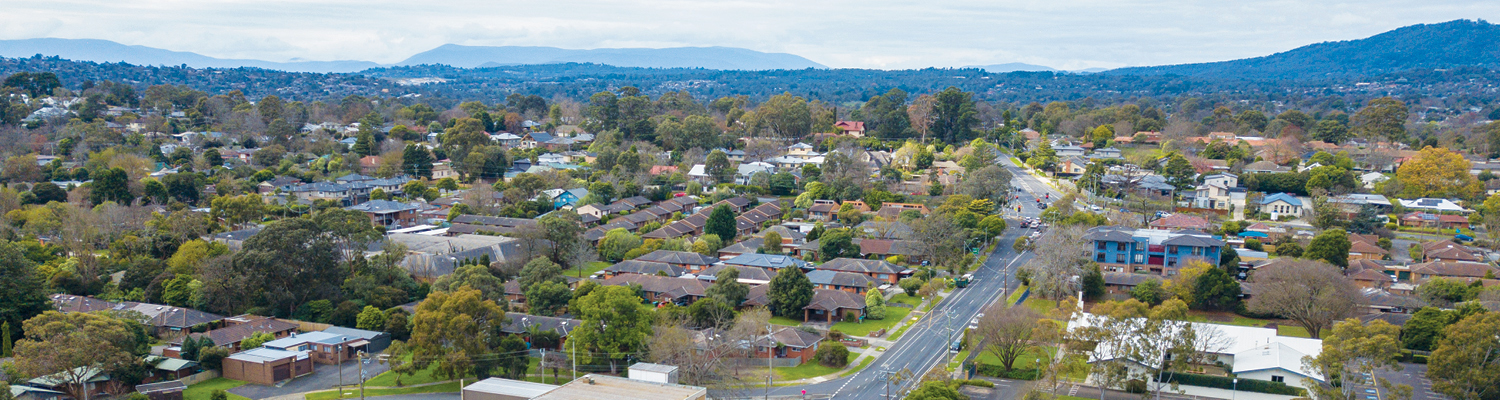 Drone shot of Croydon looking down at Hewish Road, with the Dandenong Ranges in the background