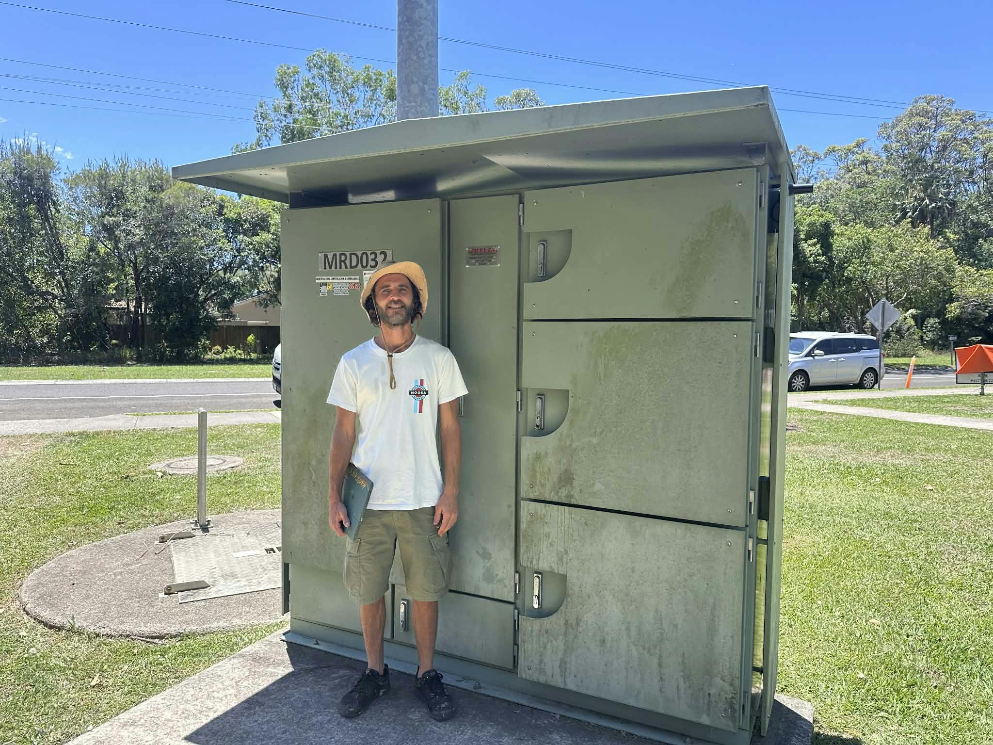Artist Kyle in front of cabinet