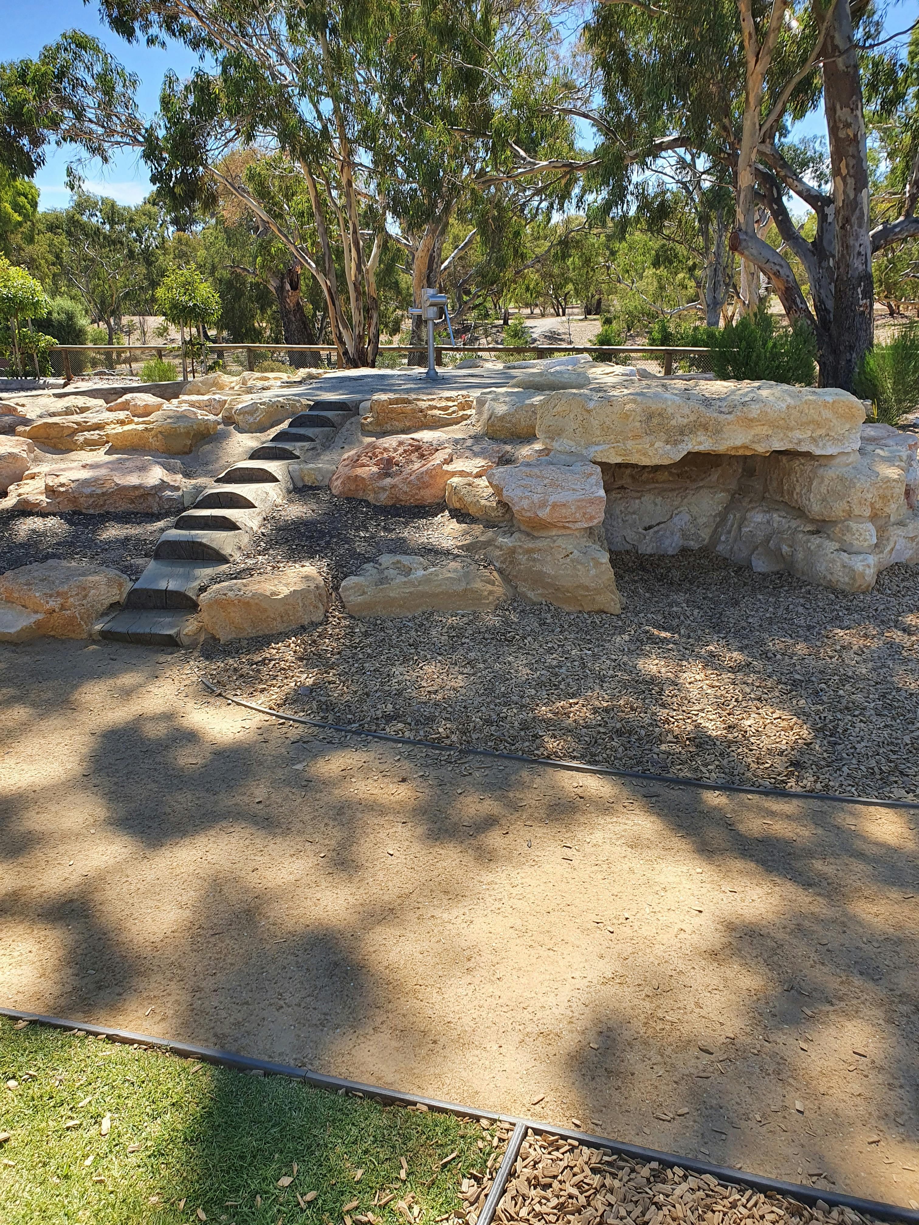 Stone climbing feature incorporating water play