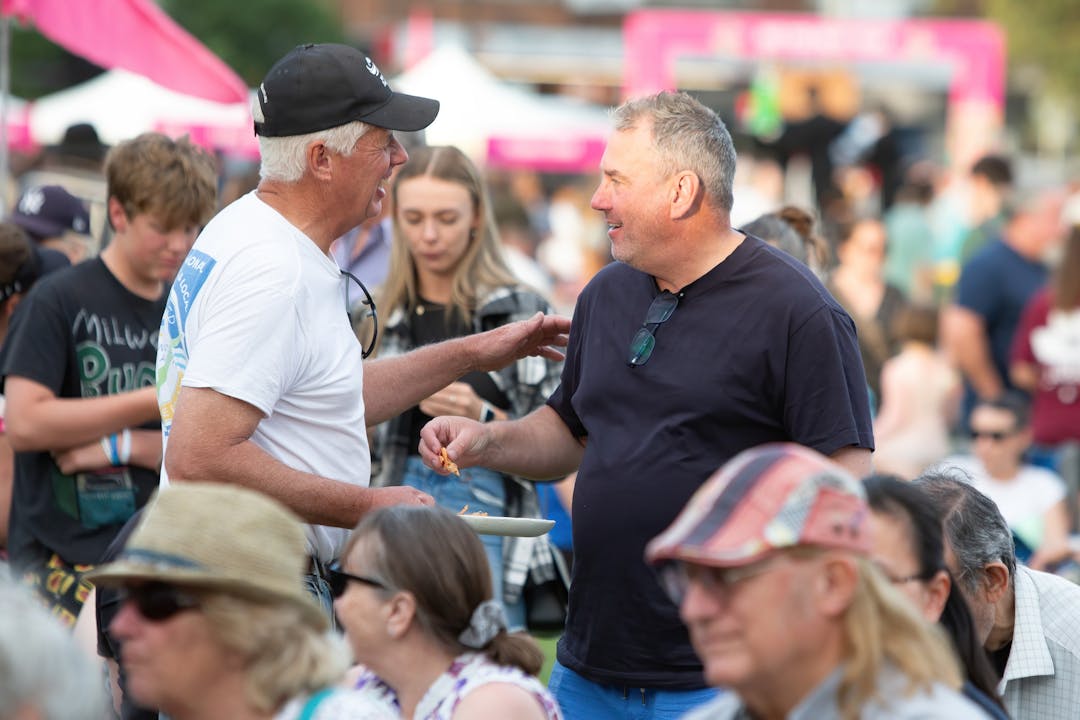 Two men interacting at a Hawkesbury event.