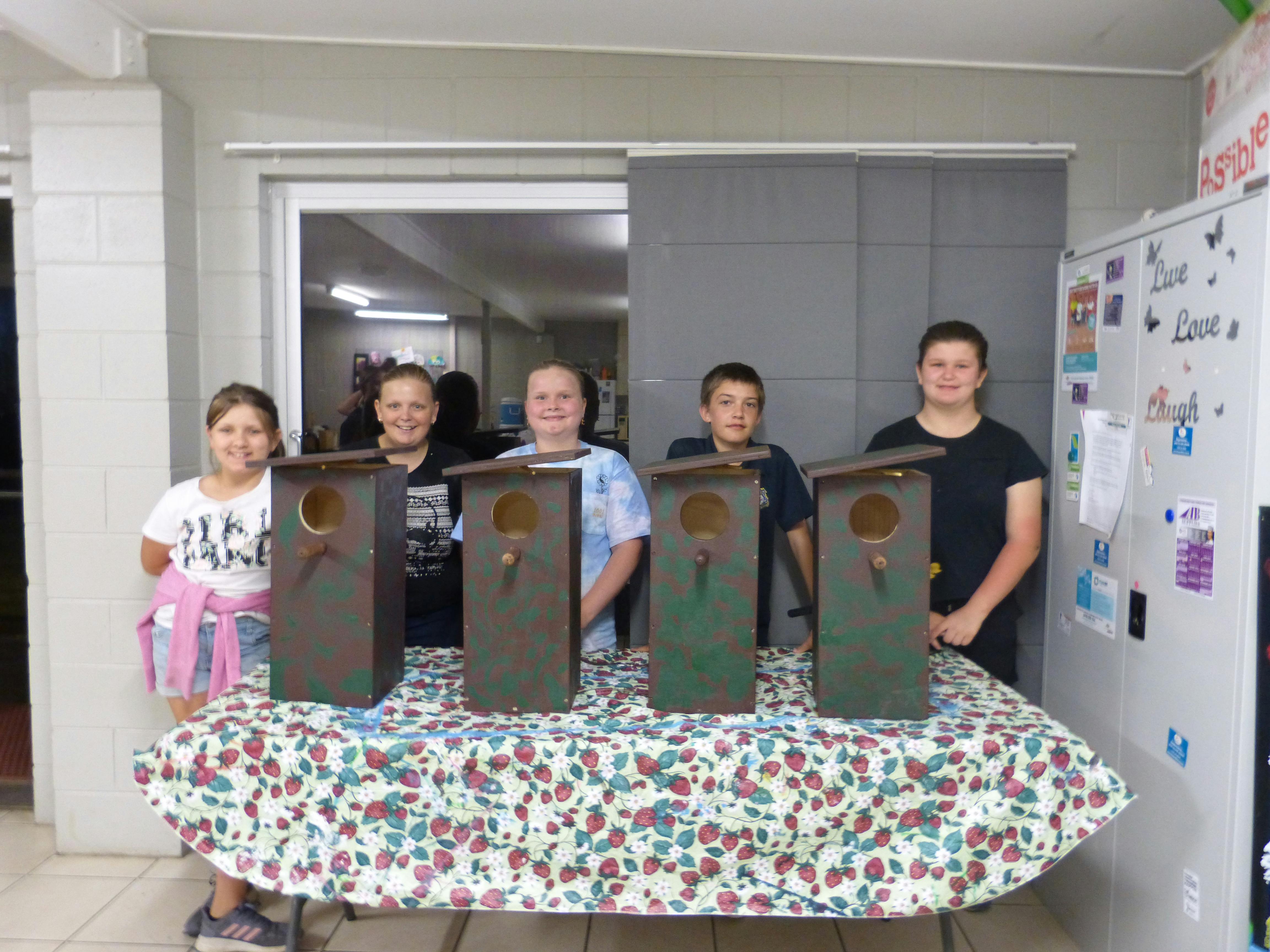 Amelia Peace, Jade Stevens, Zoe Harvey, Justin Shaxson, Jezibell Wilson with the possum boxes they built with assistance from the Moore Park Beach Mens' Shed