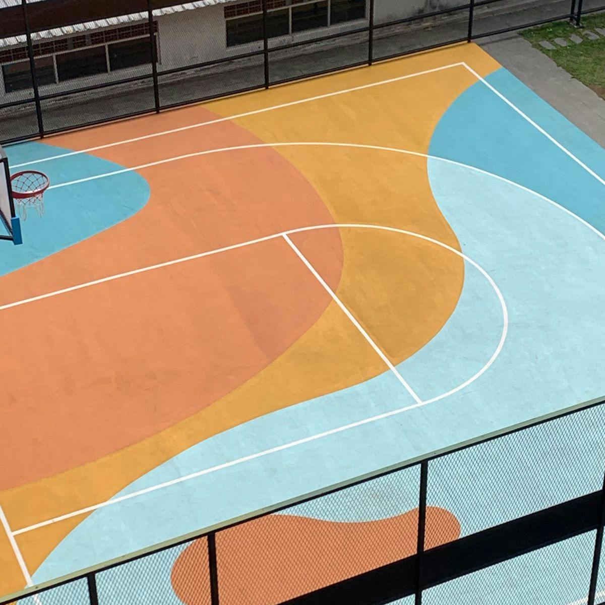 Fenced half court with linemarking and decorative floor mural 