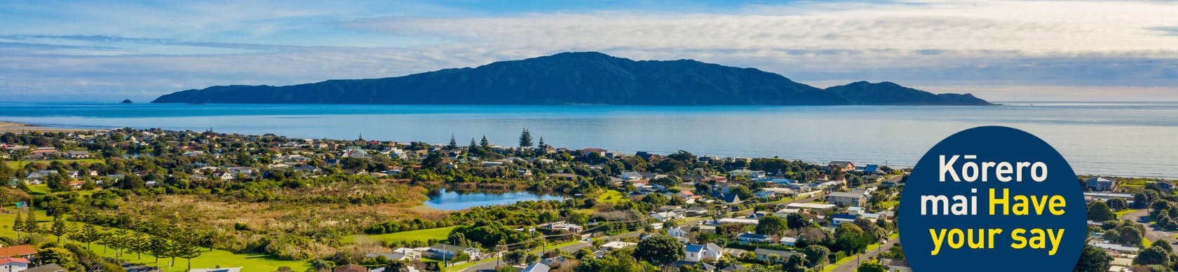 Waikanae Beach from the air, looking to Kāpiti Island, with "Kōrero mai, have your say" in a blue bubble. 