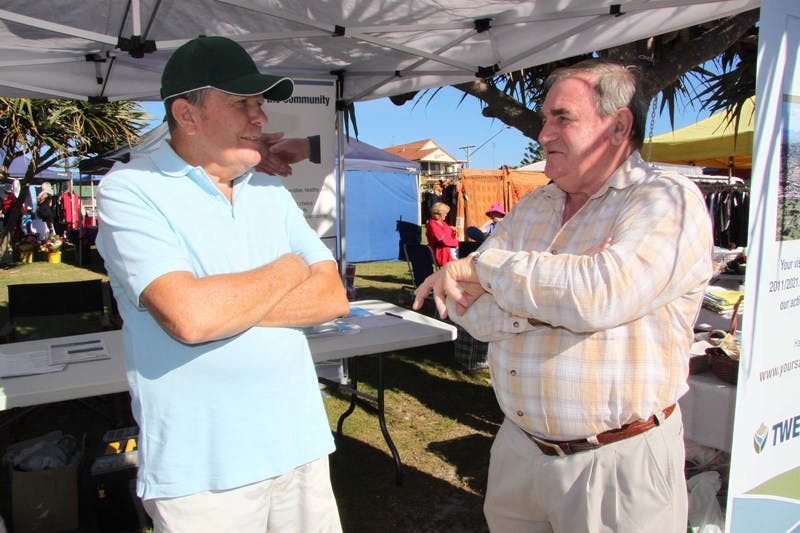 Ron Parks (left) of Kingscliff speaks to Tweed Councillor Warren Polglase at the community information stall at the Kingscliff Markets.