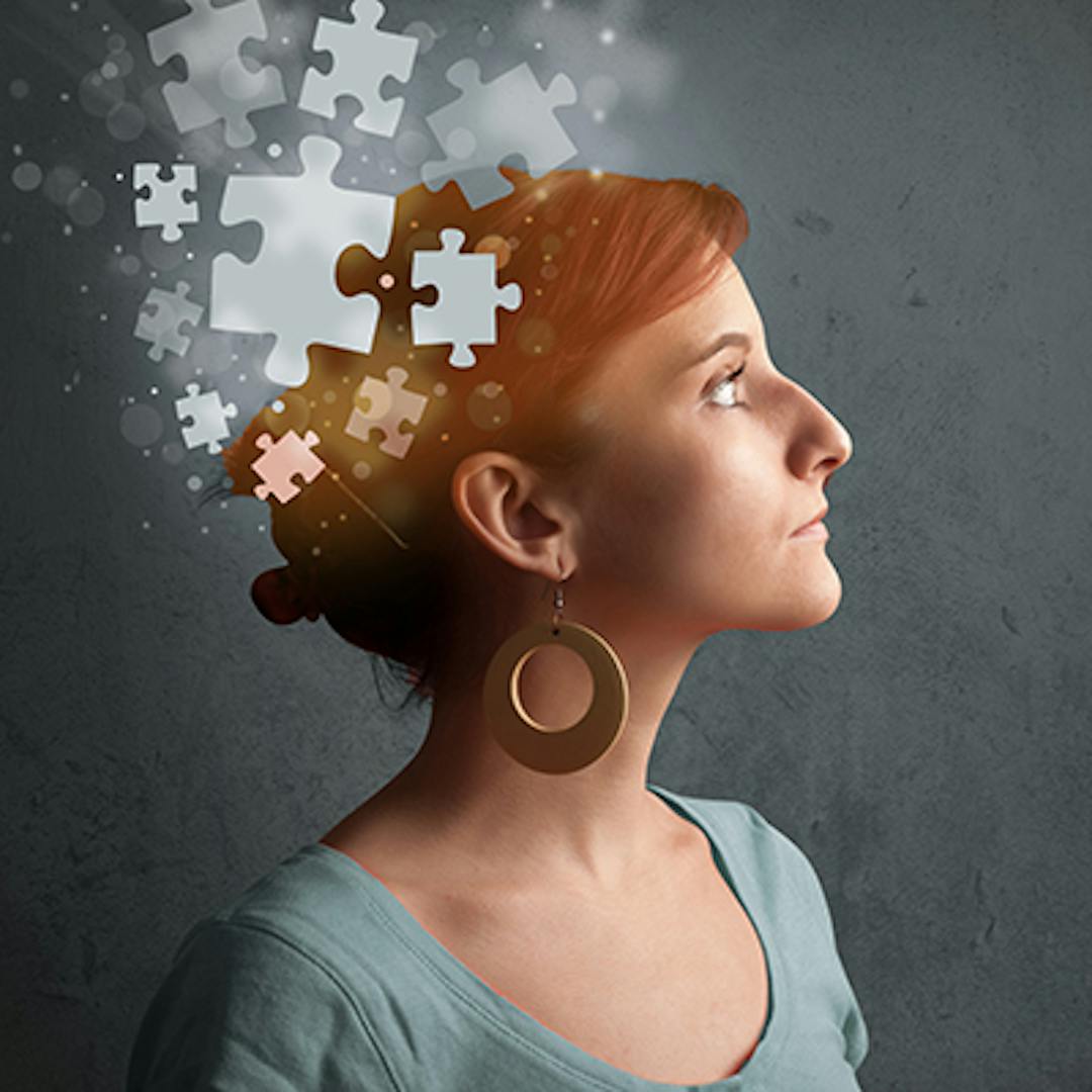 Image of woman looking out of frame with jigsaw puzzle pieces flowing from her hear (mental health image)
