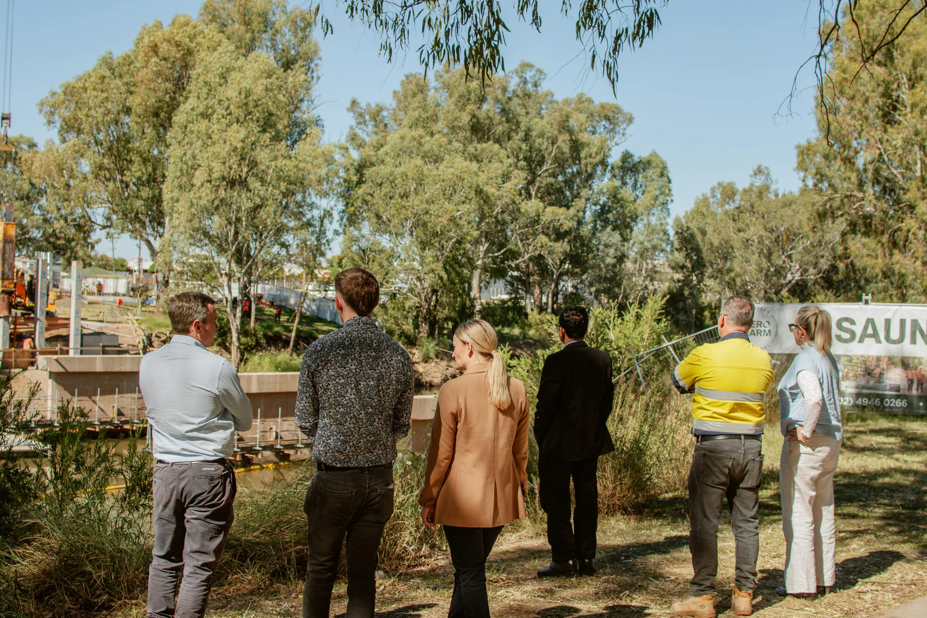 Councillors and senior staff view piling works at the bridge.